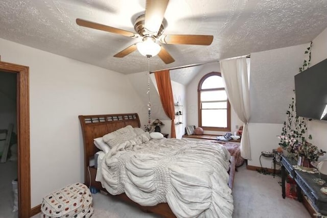 carpeted bedroom featuring a textured ceiling and ceiling fan