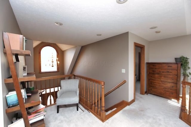 living area with baseboards, an upstairs landing, a chandelier, and carpet flooring