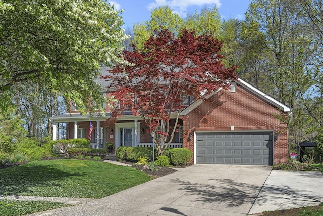 view of front of house with driveway, covered porch, a front yard, and brick siding