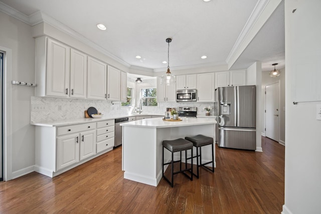 kitchen featuring tasteful backsplash, white cabinets, stainless steel appliances, and a sink