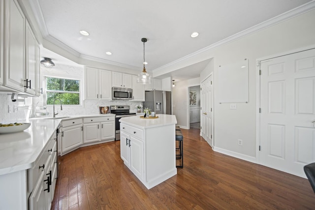 kitchen featuring white cabinets, a sink, stainless steel appliances, dark wood-style floors, and backsplash