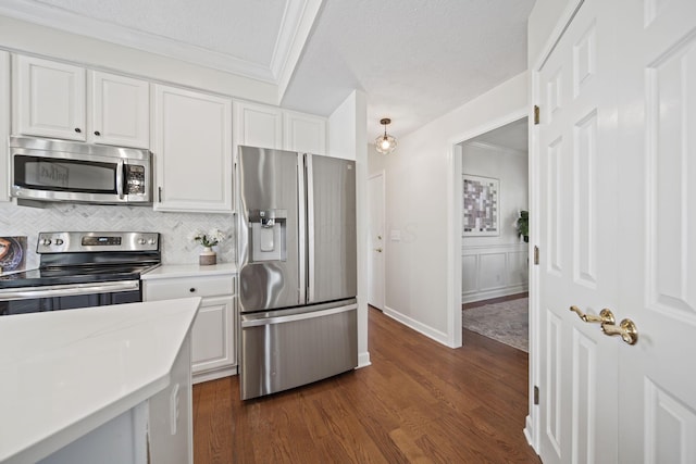 kitchen featuring white cabinetry, appliances with stainless steel finishes, light countertops, and decorative backsplash