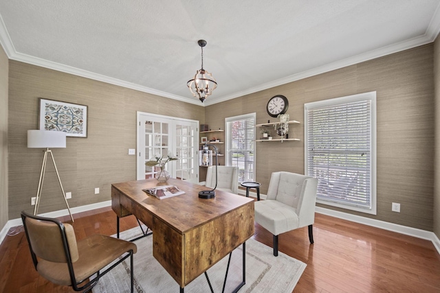 office space featuring french doors, baseboards, an inviting chandelier, ornamental molding, and wood finished floors