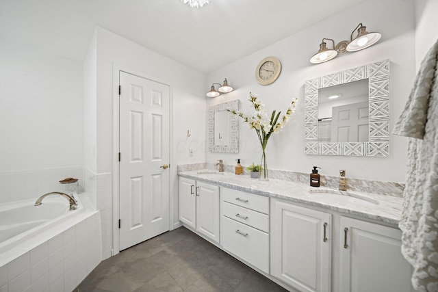 bathroom featuring tile patterned floors, a garden tub, double vanity, and a sink