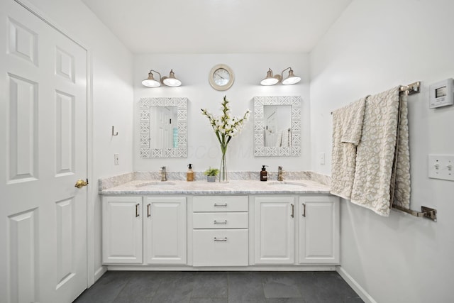 bathroom with double vanity, tile patterned flooring, and a sink