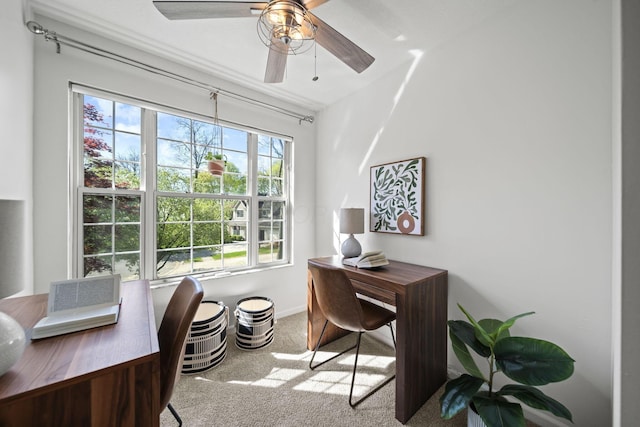 carpeted home office featuring baseboards and a ceiling fan