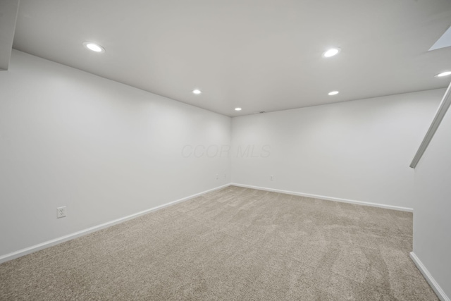 empty room with recessed lighting, carpet floors, and baseboards