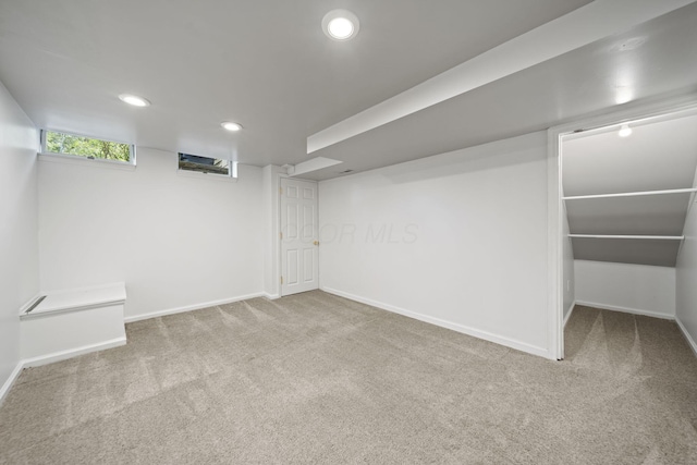 basement featuring baseboards, recessed lighting, and carpet