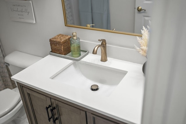 bathroom featuring vanity and toilet