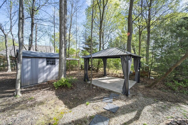 view of yard with an outbuilding, a gazebo, and a storage unit