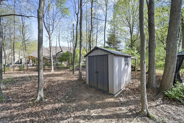 view of shed with fence