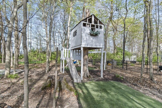 view of outbuilding featuring fence