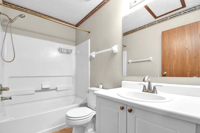 bathroom featuring a textured ceiling, bathtub / shower combination, vanity, and toilet