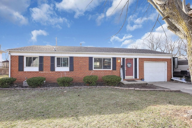 ranch-style home with brick siding, a front lawn, roof with shingles, a garage, and driveway