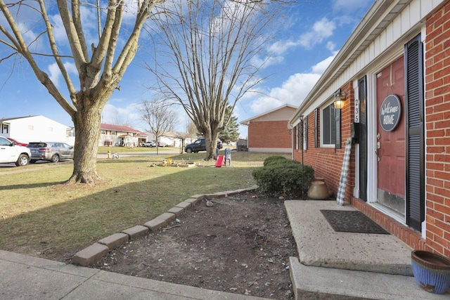 view of yard with entry steps and a residential view