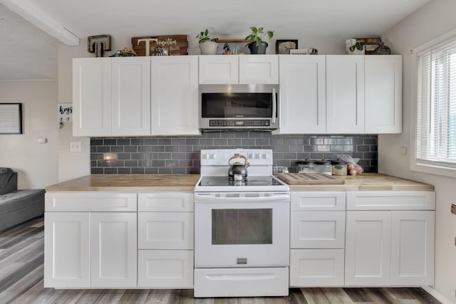 kitchen featuring stainless steel microwave, white cabinets, and white electric range oven