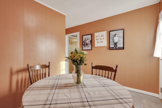 dining room featuring crown molding and baseboards