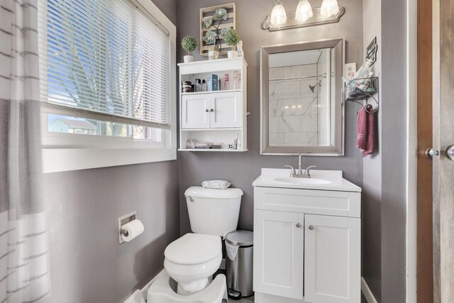 bathroom featuring vanity, toilet, and a shower