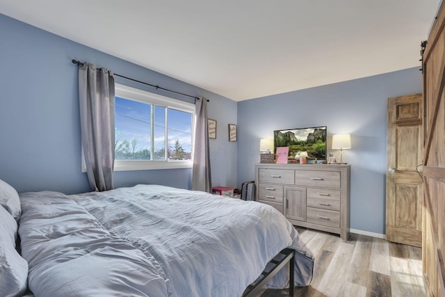 bedroom with baseboards and light wood-style floors