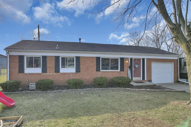 ranch-style home featuring roof with shingles, a front lawn, concrete driveway, a garage, and brick siding