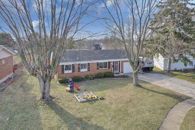 ranch-style home with a front yard, an attached garage, brick siding, and driveway