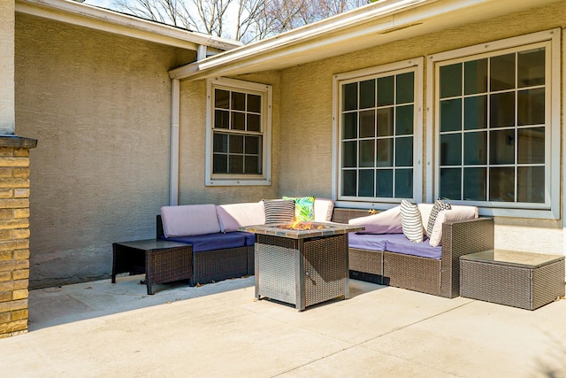 view of patio featuring an outdoor living space with a fire pit