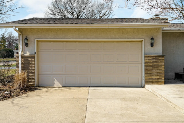 garage featuring concrete driveway