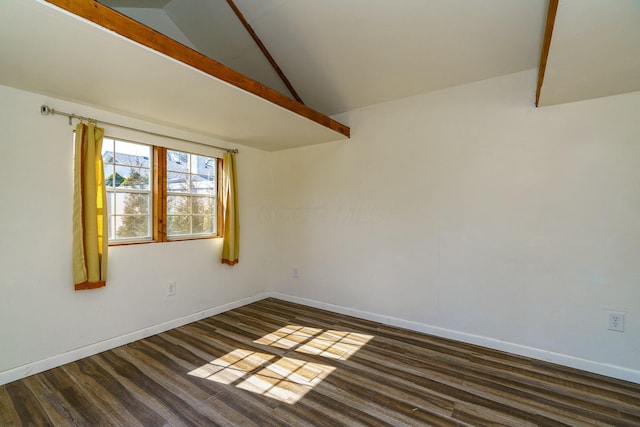 spare room with vaulted ceiling, baseboards, and dark wood-type flooring