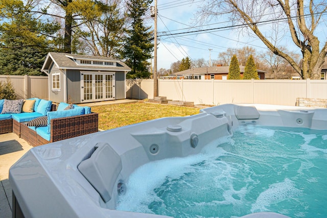 view of pool with an outbuilding, a fenced backyard, an exterior structure, an outdoor hangout area, and a hot tub