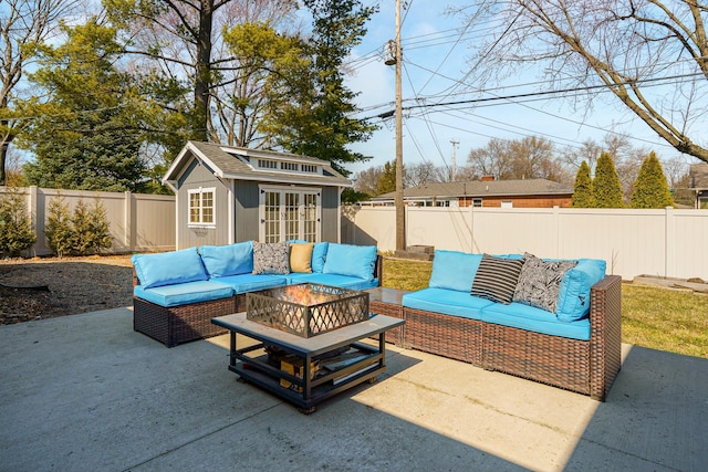 view of patio / terrace with an outbuilding, an outdoor hangout area, a fenced backyard, and an exterior structure