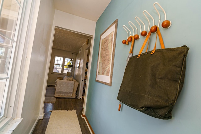 hallway with baseboards and dark wood finished floors