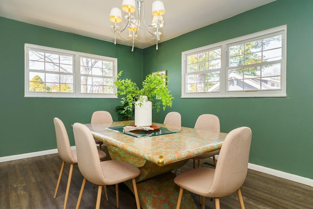 dining area with an inviting chandelier, dark wood-style floors, and baseboards