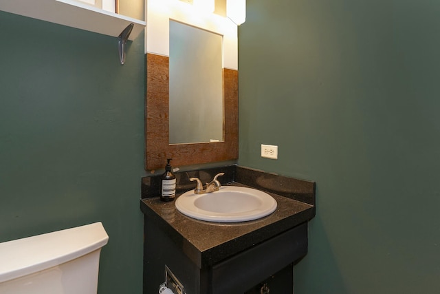 bathroom featuring toilet and vanity