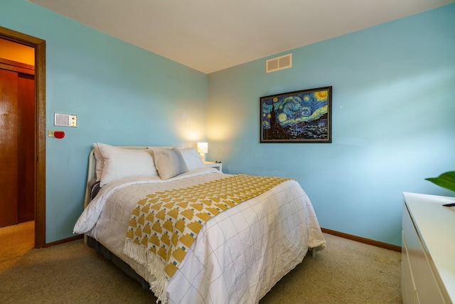 carpeted bedroom featuring visible vents and baseboards