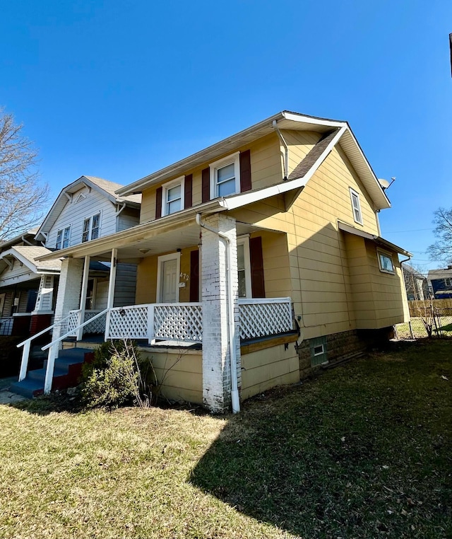 view of front of home with covered porch and a front yard