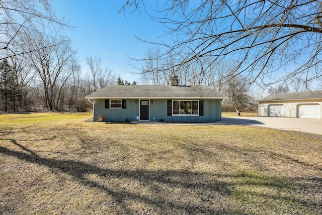 view of front of property with an outbuilding, a front lawn, and a chimney