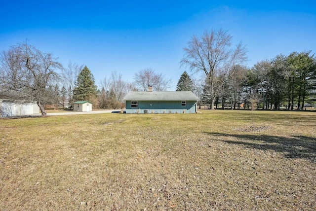 view of yard featuring a storage unit and an outbuilding