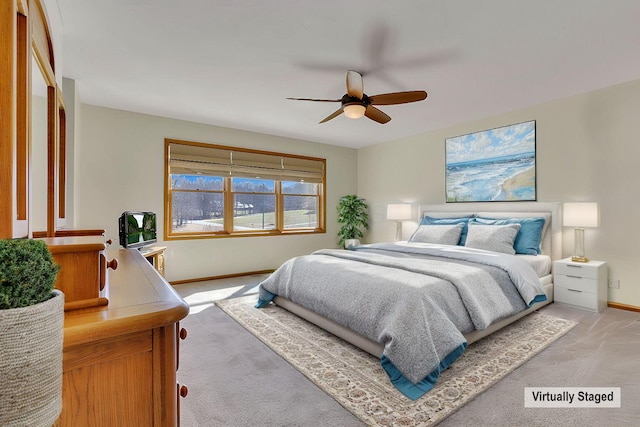 bedroom with a ceiling fan, light colored carpet, and baseboards