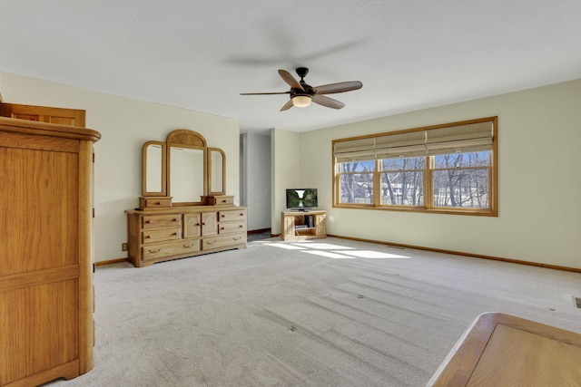 unfurnished bedroom featuring carpet flooring, baseboards, and ceiling fan