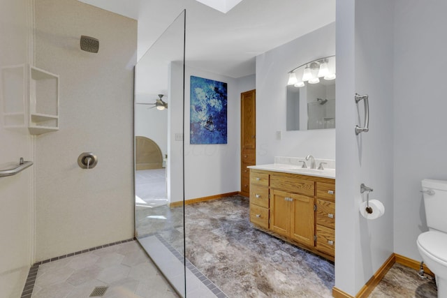 bathroom featuring baseboards, toilet, walk in shower, and a ceiling fan