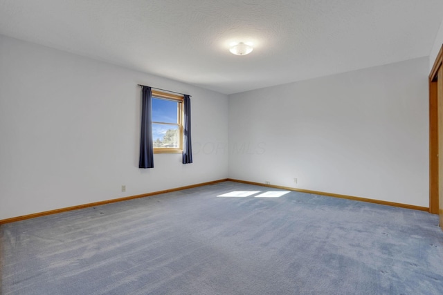 carpeted spare room with baseboards