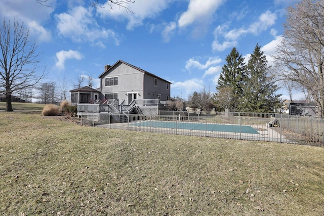 view of pool with a wooden deck, a lawn, a fenced in pool, and fence