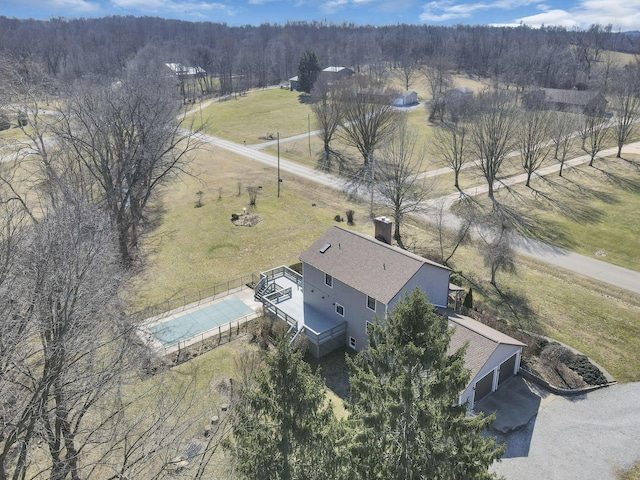 birds eye view of property with a rural view and a wooded view