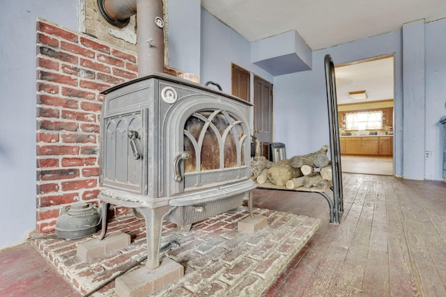 details with wood finished floors and a wood stove