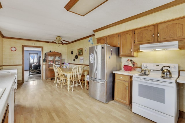 kitchen featuring crown molding, under cabinet range hood, white range with electric cooktop, light countertops, and freestanding refrigerator