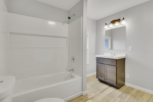 full bath featuring shower / bath combination, baseboards, toilet, and wood finished floors