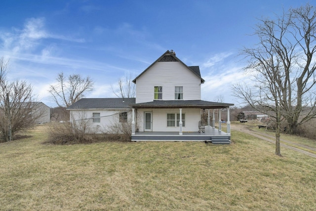 back of property featuring a lawn