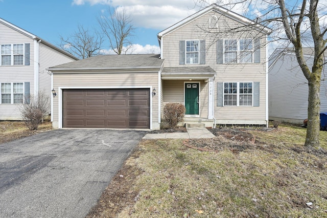 traditional home with an attached garage and driveway