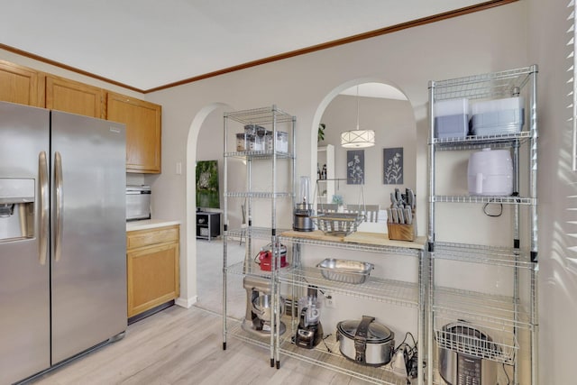 kitchen with arched walkways, ornamental molding, stainless steel refrigerator with ice dispenser, decorative light fixtures, and light wood-type flooring