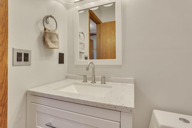 half bathroom with toilet and vanity